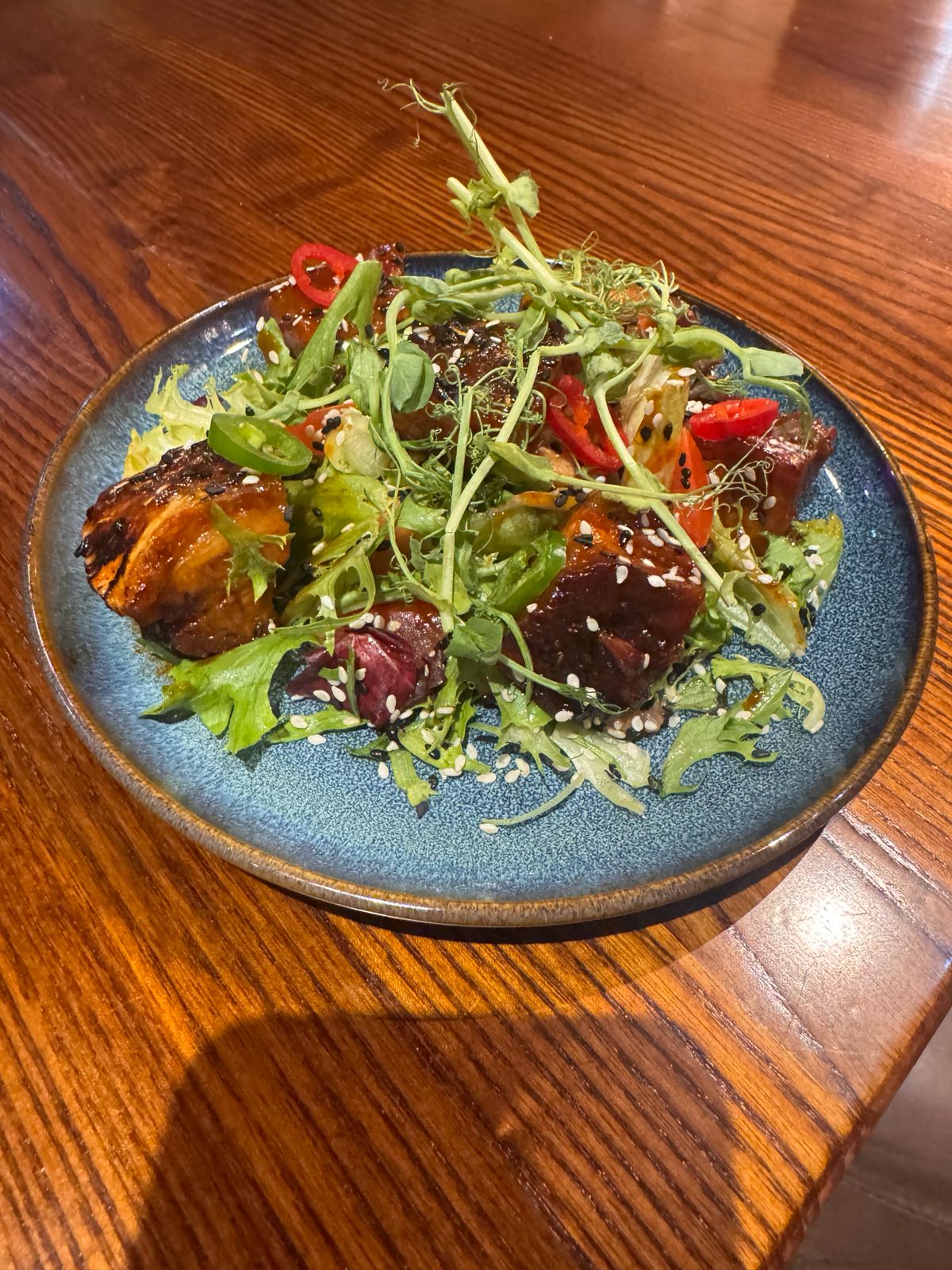 Asian glazed beef salad with sesame, chilli and pea shoots